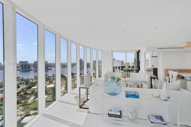 sunroom / solarium with a water view and plenty of natural light