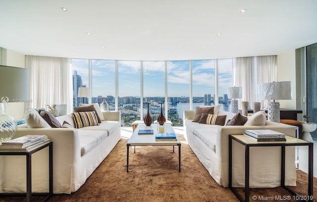 living room with expansive windows and a water view