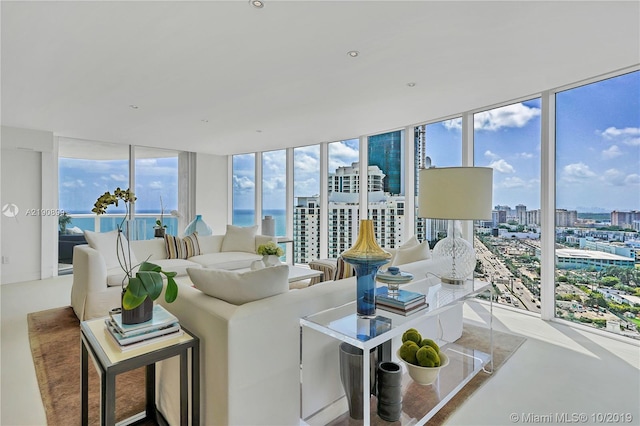 living room with a wall of windows and a water view