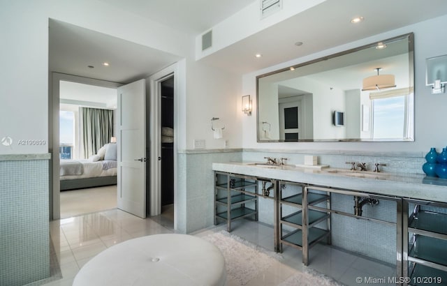 bathroom featuring tile patterned flooring, vanity, and decorative backsplash