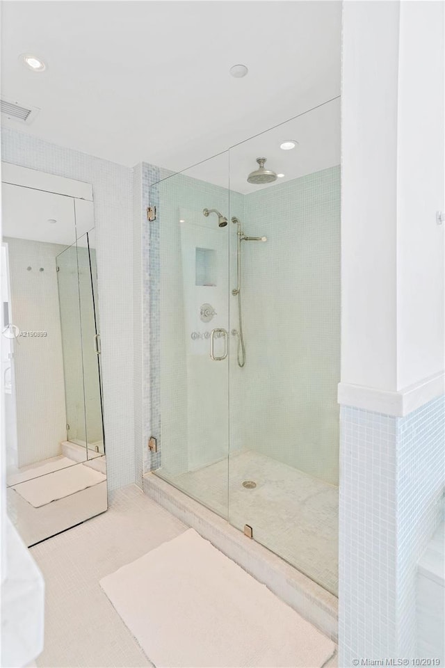 bathroom featuring an enclosed shower and tile patterned floors