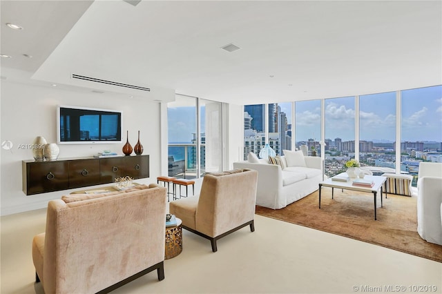 living room featuring floor to ceiling windows and light colored carpet