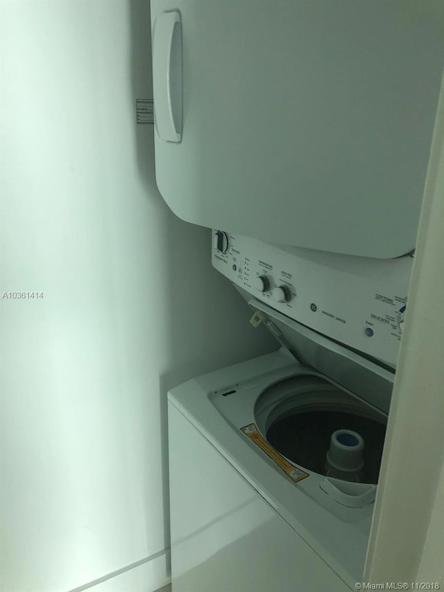 laundry room featuring stacked washing maching and dryer