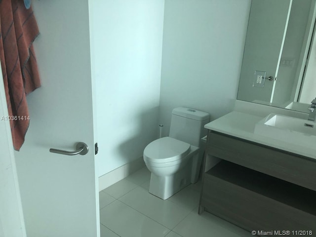 bathroom with toilet, tile patterned floors, and vanity