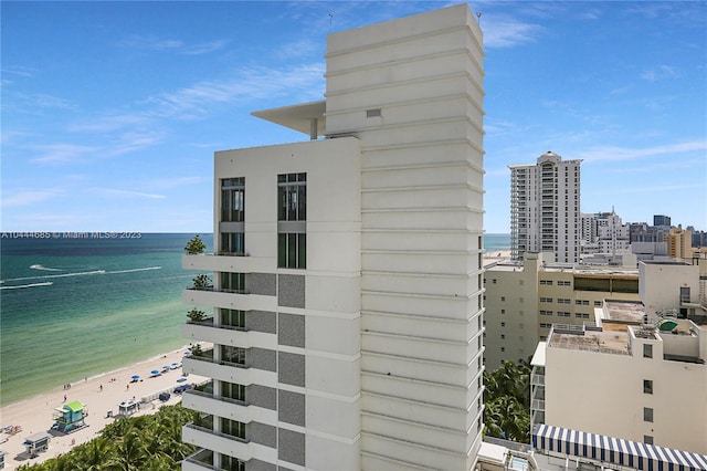 exterior space featuring a water view and a view of the beach