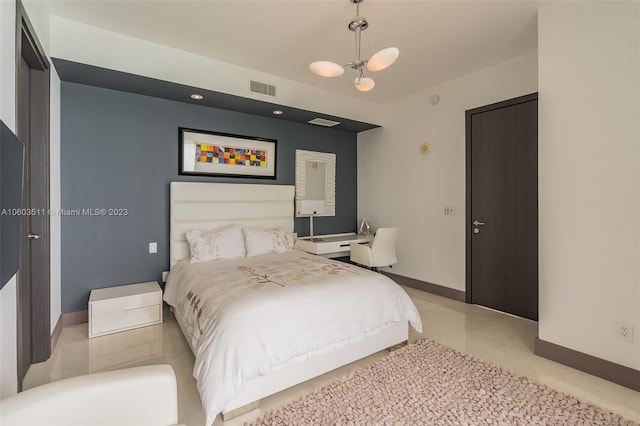 tiled bedroom featuring a chandelier