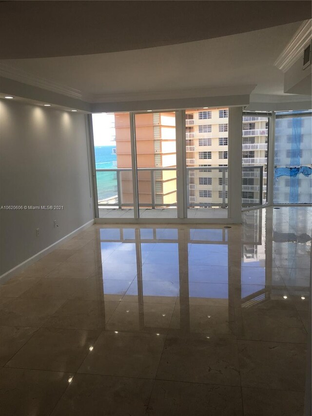 spare room with tile patterned flooring and floor to ceiling windows