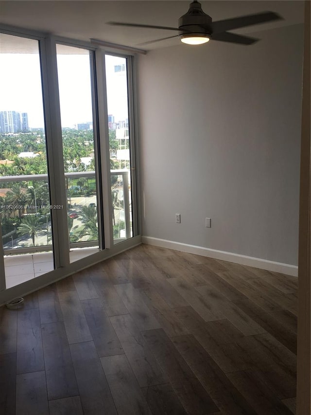 unfurnished room featuring dark hardwood / wood-style flooring and ceiling fan