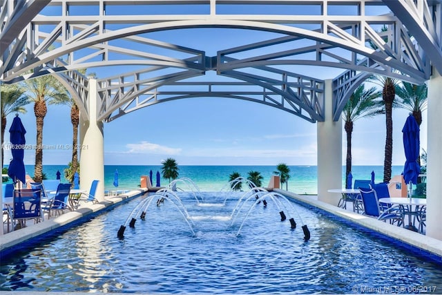 view of swimming pool featuring a water view