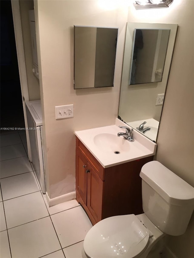 bathroom featuring toilet, tile flooring, and vanity