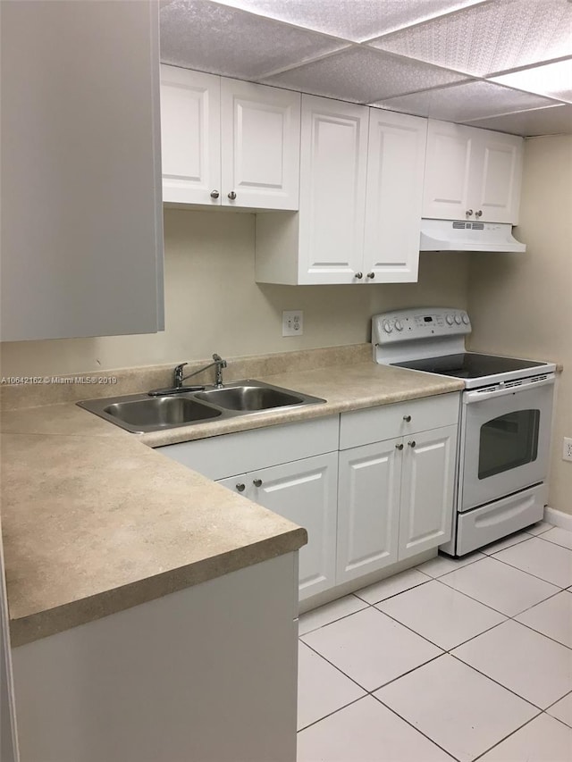 kitchen featuring light tile flooring, white electric range oven, custom exhaust hood, sink, and white cabinets