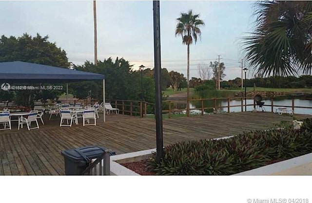 deck with a gazebo and a water view