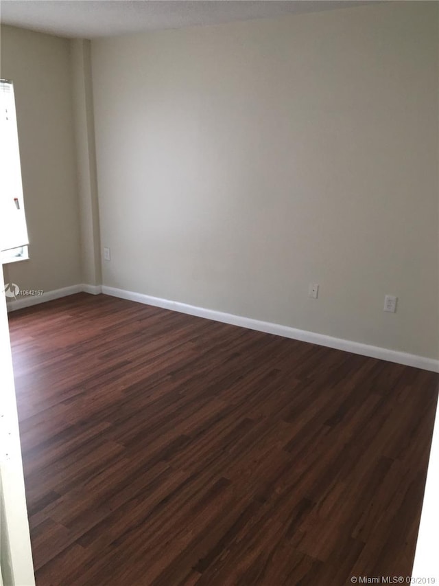 empty room featuring dark hardwood / wood-style floors