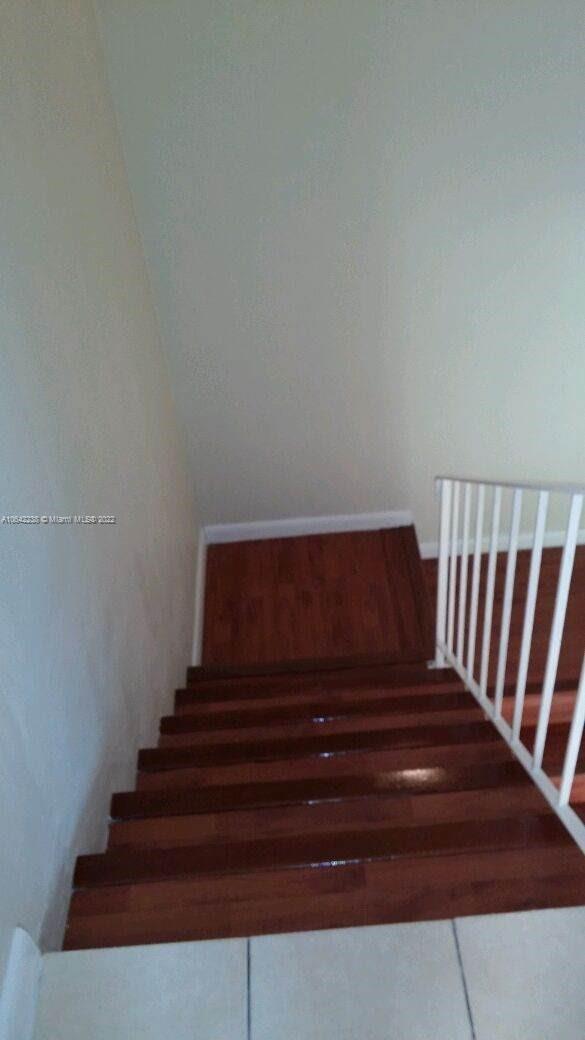 stairs featuring hardwood / wood-style floors