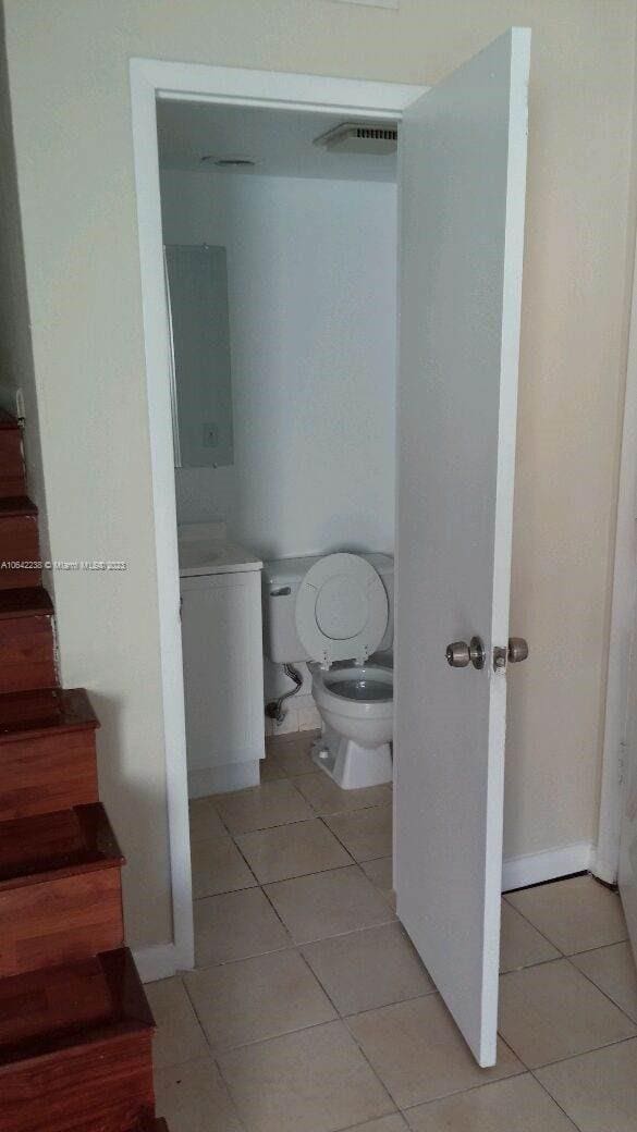 bathroom featuring toilet and tile patterned floors