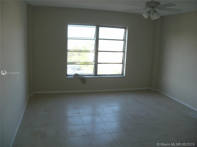 unfurnished room with light tile floors and ceiling fan