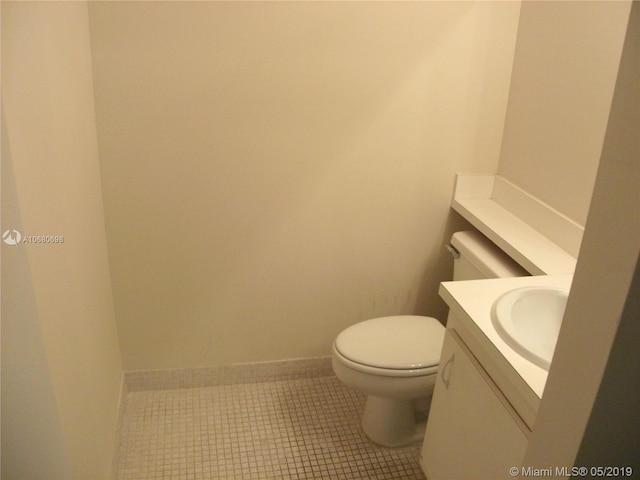 bathroom featuring vanity, tile flooring, and toilet