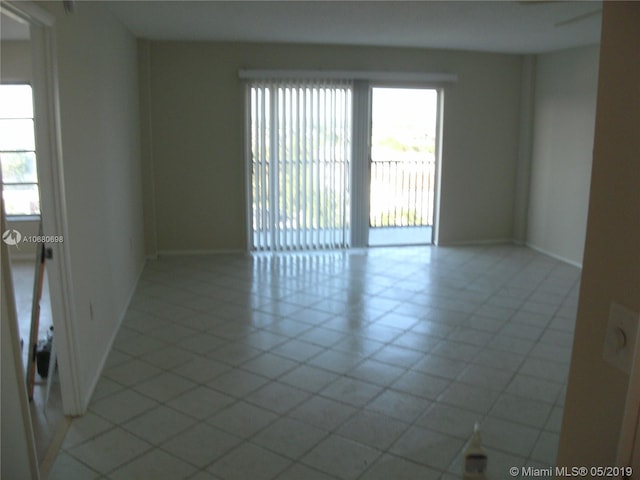 tiled empty room with a wealth of natural light