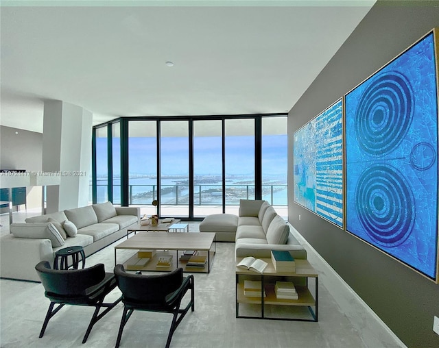 living room with floor to ceiling windows and a water view