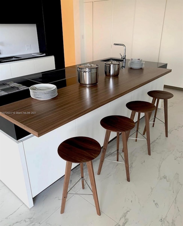 kitchen with a kitchen breakfast bar and sink