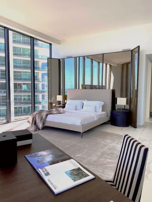 bedroom with hardwood / wood-style floors and floor to ceiling windows