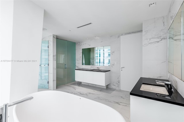 bathroom with tile walls, separate shower and tub, vanity, and tile flooring