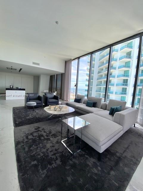 living room featuring plenty of natural light and floor to ceiling windows