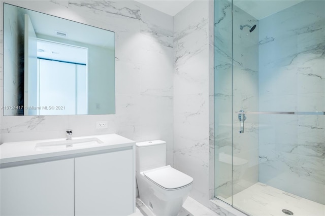 bathroom with tile walls, a shower with shower door, oversized vanity, and toilet