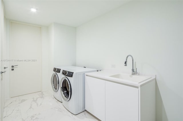 laundry room with washer and dryer, light tile floors, and sink