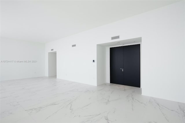 unfurnished room with light tile floors