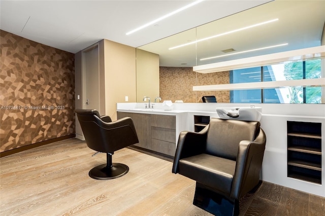 bar featuring sink and light hardwood / wood-style flooring