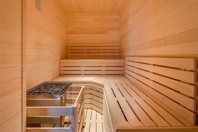 view of sauna with wood walls