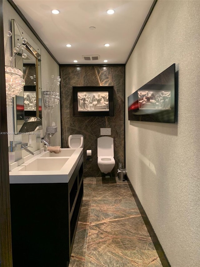 bathroom featuring vanity, tile floors, toilet, and tile walls