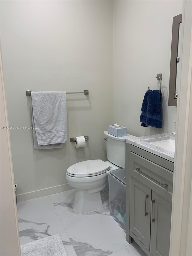 bathroom featuring toilet, tile floors, and vanity