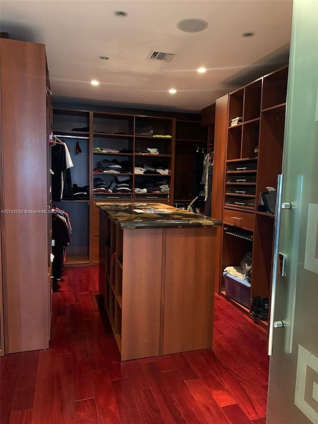 spacious closet featuring dark hardwood / wood-style flooring