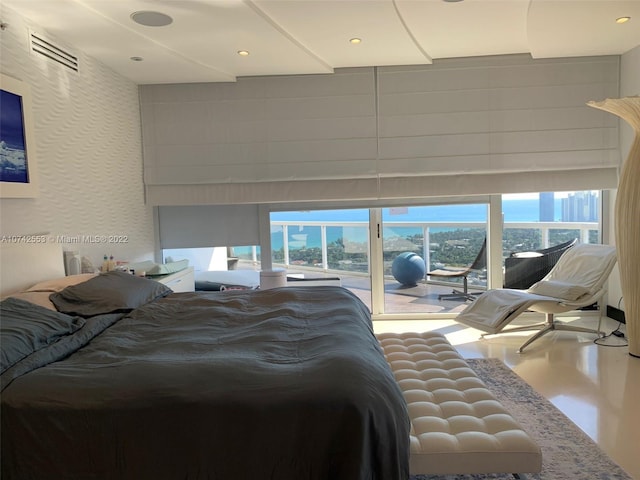 bedroom featuring concrete flooring and multiple windows