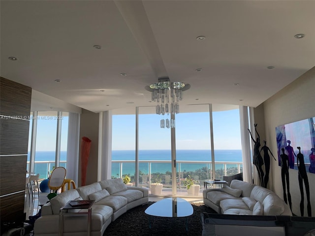 living room with a water view, a wall of windows, and a wealth of natural light