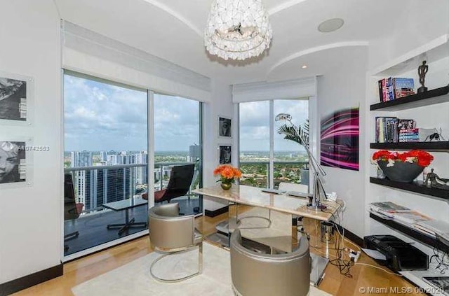 office space with a notable chandelier and light hardwood / wood-style flooring