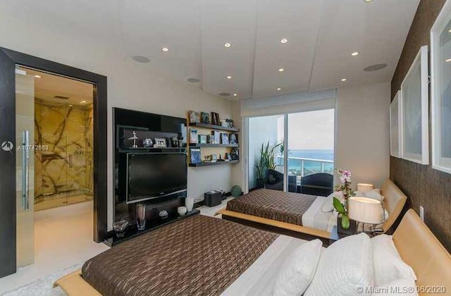 bedroom with a water view and ensuite bath