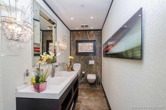 bathroom featuring tile walls, toilet, vanity, and tile floors