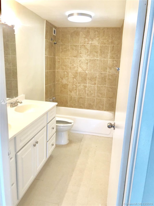 full bathroom featuring tile patterned floors, vanity, toilet, and tiled shower / bath