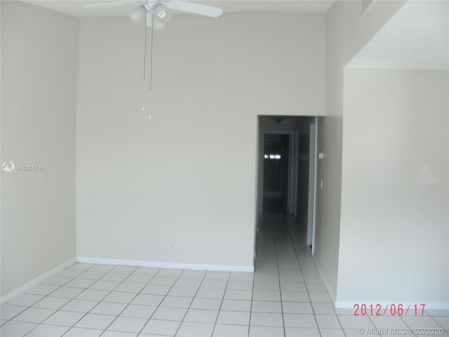 spare room with ceiling fan and light tile patterned floors