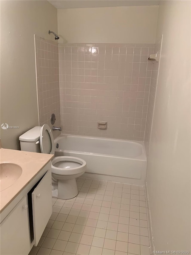 full bathroom featuring toilet, vanity, tile patterned floors, and tiled shower / bath combo