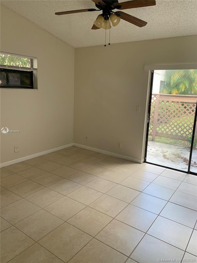 spare room featuring light tile patterned floors, a textured ceiling, ceiling fan, and lofted ceiling