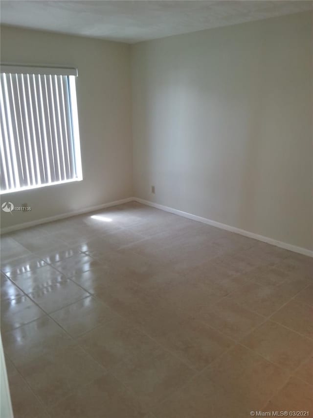 spare room with light tile patterned floors