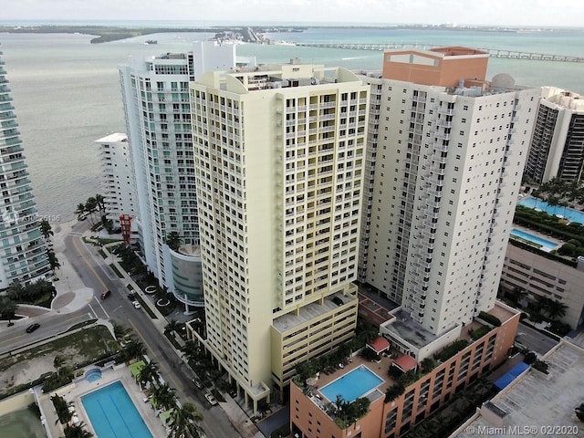 birds eye view of property featuring a water view and a view of city