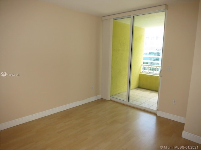 interior space with a closet, light wood-style flooring, and baseboards