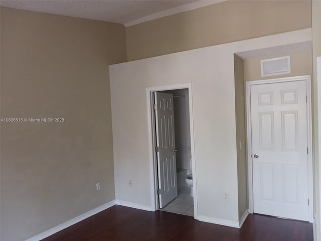 spare room with dark wood-type flooring