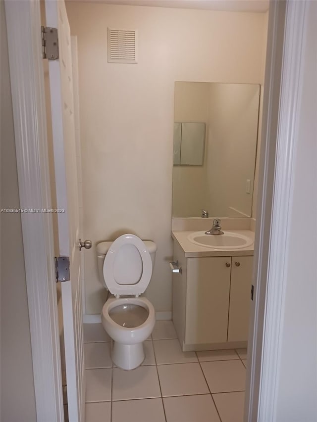 bathroom featuring tile patterned floors, vanity, and toilet