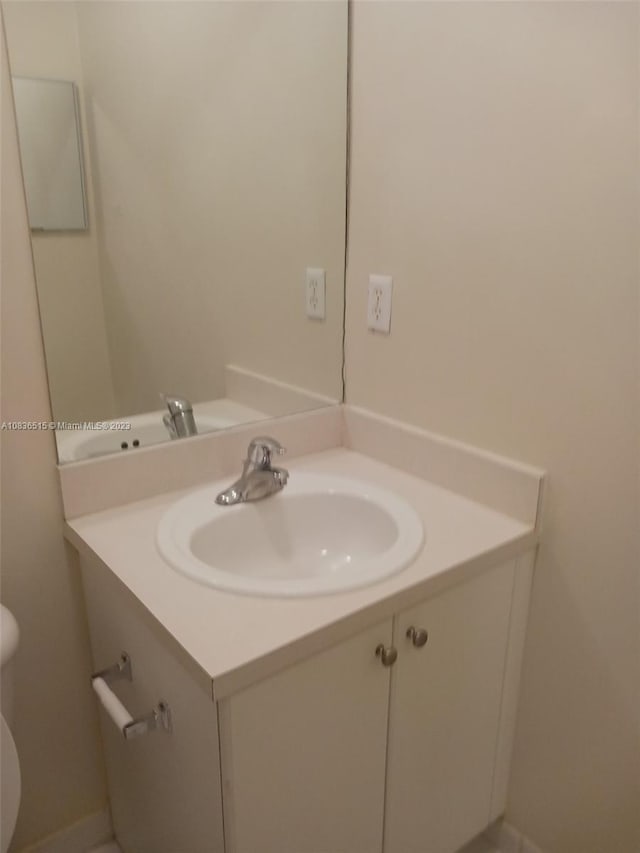 bathroom featuring vanity and toilet